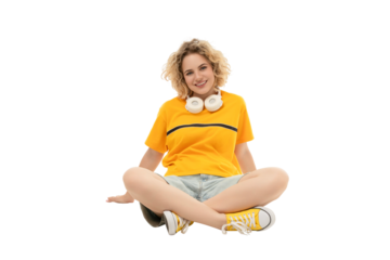 Woman in casual wear with headphones seated, isolated on white, PNG