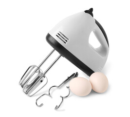 Electric mixer with chrome beaters and eggs on white background