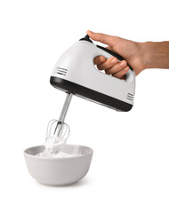 Female hand with electric mixer and bowl of whipped cream on white background