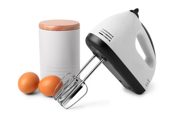Electric mixer with jar of flour and eggs on white background