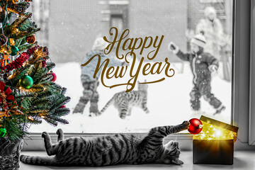 Festive feline and snowy christmas scene.
Cat playfully lying on its back under a decorated Christmas tree. A glass ornament with colorful trees hangs nearby.