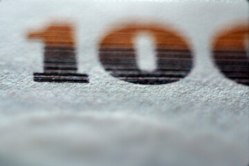 Close-Up View of Textured Paper with Large Number One Hundred Detail
