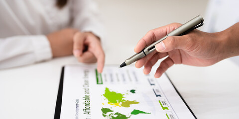 Close up hands of A businessman in meeting room, presentation ESG targets Goal Affordable, reliable, sustainable and modern energy Sustainable of Green ecology and alternative renewable energy.