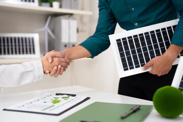 Renewable energy Partnership. Two professional businessmen exchanging a handshake for business deal.