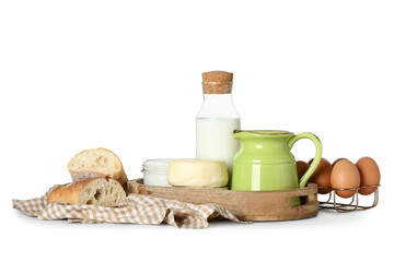 Wooden tray with different dairy products, bread, eggs and napkin on white background