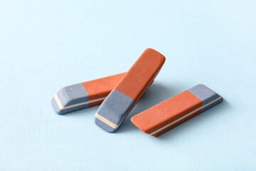 School erasers on blue background