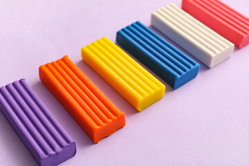 Colorful plasticine on lilac background