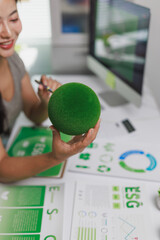 Woman holding green sphere planning esg strategy