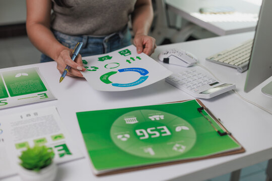 Person analyzing esg report for sustainable business strategy