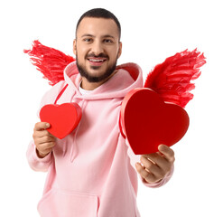 Young man with Cupid's wings and gift boxes on white background. Valentine's Day celebration