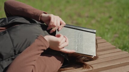 lady reads outdoors, woman finds tranquility as she reads peacefully in natural surroundings, lady experiences serenity while leisurely reading her favorite book outdoors amidst nature