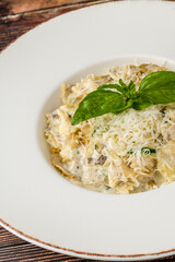 Creamy mushroom pasta topped with grated Parmesan and fresh basil