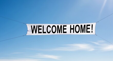 A welcoming banner declaring welcome home against a clear blue sky