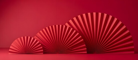 Festive display of three elegant red paper fan decorations in various sizes, set against a vibrant monochromatic red background