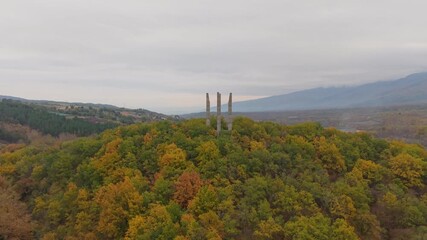 Aerial drone approaches Samuil's Fortress on a hill in Bulgaria, gradually revealing the historic monument and its elevated hilltop position.