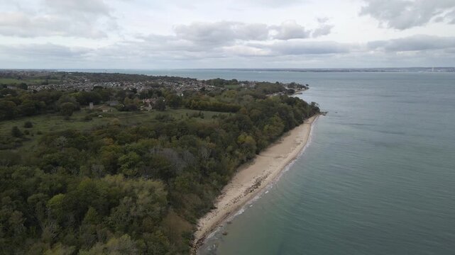 Aerial view of St Helens village named in dedication to St Helena Church, a destroyed church built in the 12th century, Cluniac priory. Only the tower of the church remains, drone moving to the right.