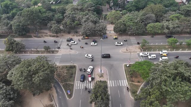 The serene urban layout of Greater Noida includes smooth roads, tree-lined paths, and rising residential towers.