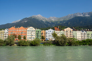 Colorful riverside houses with alpine mountain backdrop in Innsbruck Austria