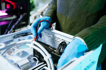 Capture the detailed work of a technician repairing a computer with a multimeter and blue gloves. Perfect for tech repair, electronics maintenance, and diagnostics themes.