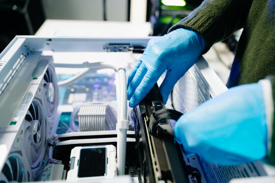 Closeup of technician testing computer motherboard with multimeter in modern lab, representing precision, innovation, and professional electronic repair service.