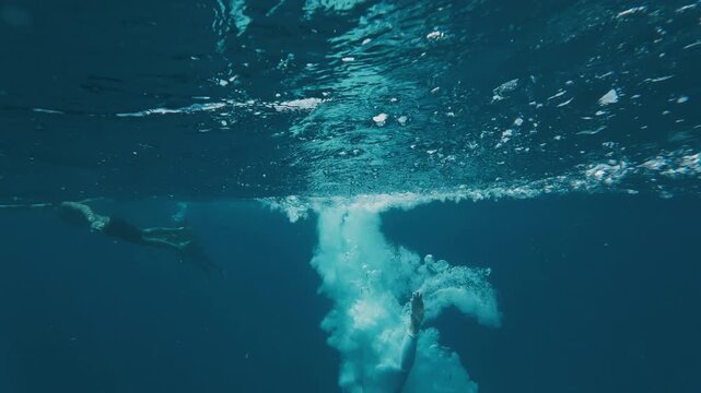 Person jumps into the sea from a boat