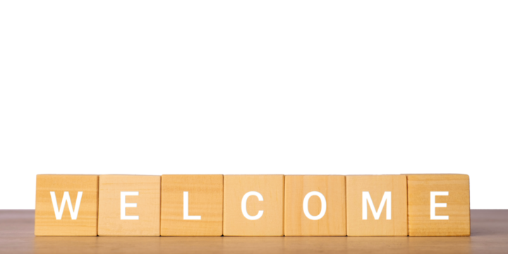 Wooden blocks with word welcome for greeting and onboarding concept, isolated on transparent background