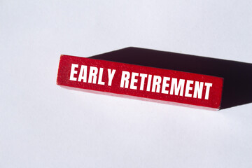 Early retirement message written on wooden block background. Conceptual Early retirement symbol....