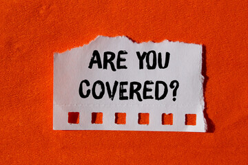 Are you covered message written on ripped torn paper background. Conceptual Are you covered symbol....
