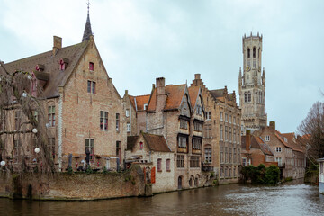 Beautiful city skyline of the village building architecture along a river rozenhoedkaai Rosary Quay canal reflection in Brugge Flanders Belgium