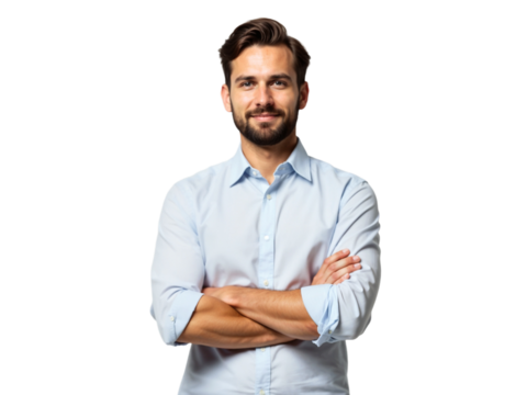 Smiling man in a light blue shirt standing confidently with arms crossed in a neutral background