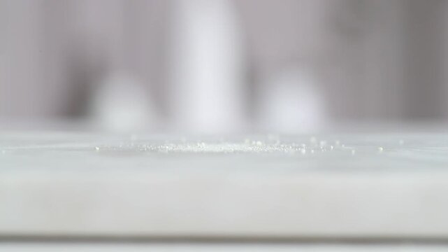 Slow motion video of falling powder