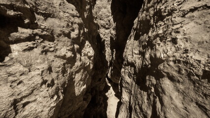 Winding through a narrow canyon, sunlight filters down, casting shadows on rugged rock walls. The path is rich in textures, inviting adventure in natures embrace.