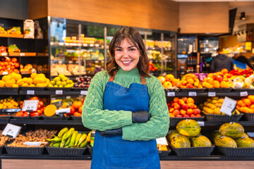 Smiling woman working at a fresh fruit market