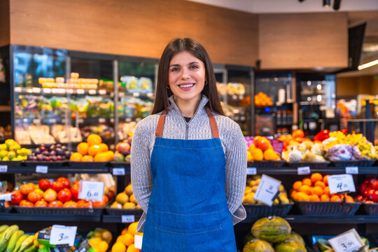 Woman working in supermarket grocer department smiling portrait
