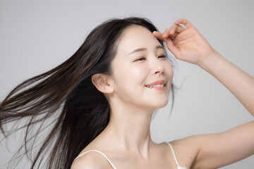 Obraz premium 風になびく黒髪のロングヘアの女性ポートレート 美容とヘアケア・トリートメントなどのイメージ クローズアップ