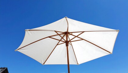 White Patio Umbrella Against a Clear Blue Sky.