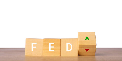 Wooden blocks with FED letters and up down arrows for interest rate decision concept, isolated on transparent background