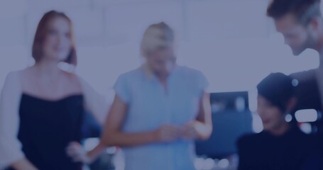 Collaborating five coworkers in work clothes discussing in bright office with computer monitor
