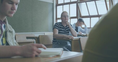 Thinking student wearing glasses and striped tee resting chin at school desk, with notebooks © vectorfusionart