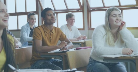 Studying six students writing at wooden desks in classroom, wearing fuzzy sweater and mustard polo © vectorfusionart