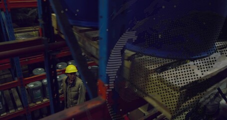 Inspecting worker wearing yellow hard hat, khaki vest scanning racks in storage, drums, copy space