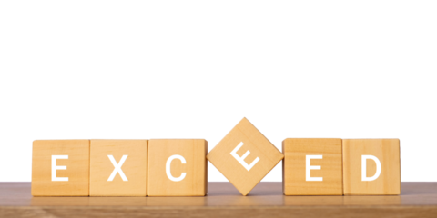 Wooden blocks with exceed word for overachievement and success concept, isolated on transparent background