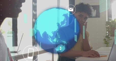 Working teen wearing T-shirt typing on laptop, resting chin at home office with holographic globe