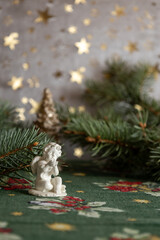 Ceramic angel figurine with evergreen branches

