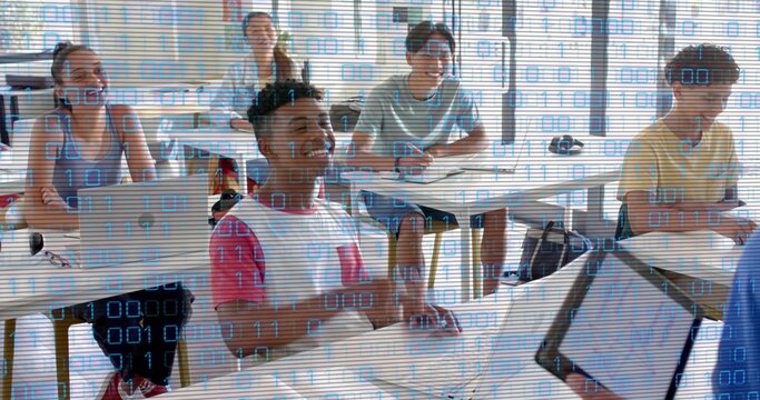 Studying teen male in white-red shirt using laptop and tablet in classroom with binary overlay