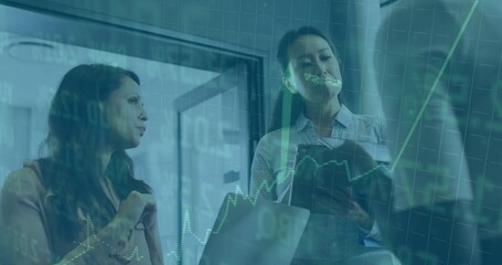 Discussing three women in business attire sharing stock graph at office, with tablet cup sandwich
