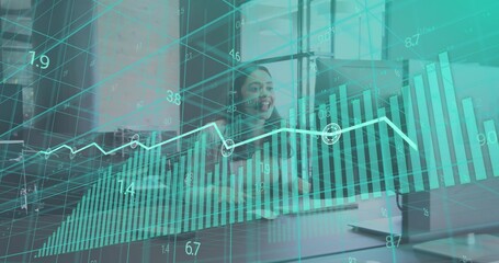Smiling woman in dark blazer presenting data in conference room, with laptop and teal charts