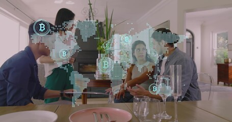 Meeting team in casual attire around wooden dining table at home, viewing tablet with Bitcoin map