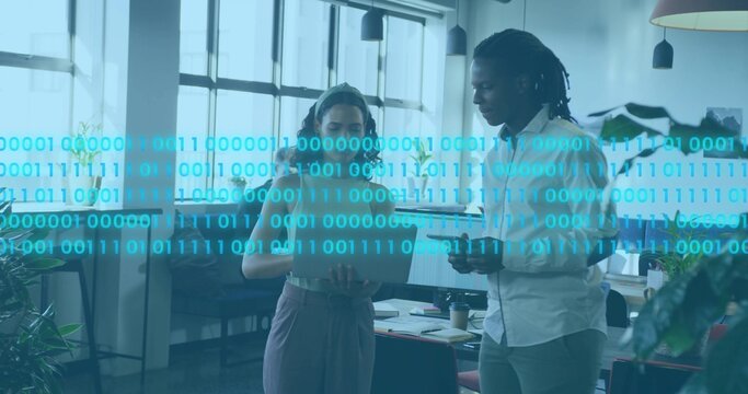 Woman in sleeveless top and man in button-down discussing tablet in office with binary overlay