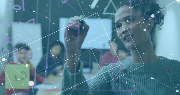 Presenting woman in sweater drawing on glass board in office, marker and yellow notes, copy space - Powered by Adobe